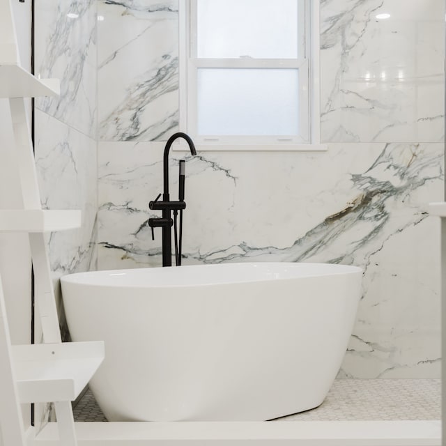 bathroom featuring a bath and sink