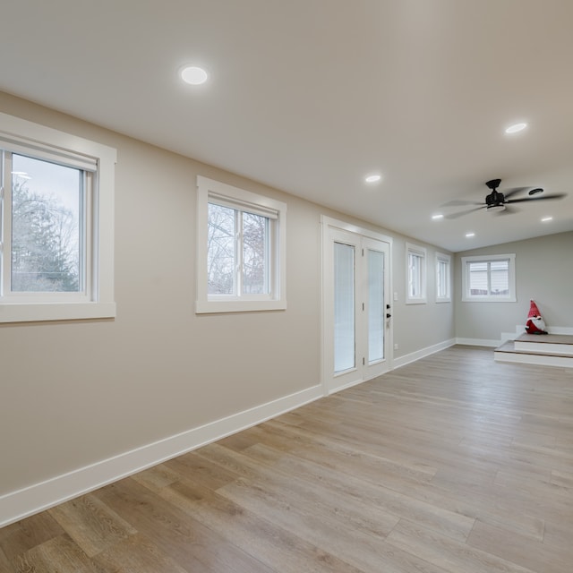 basement featuring ceiling fan and light wood-type flooring