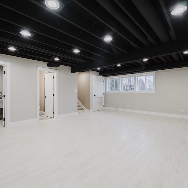 basement with light hardwood / wood-style floors