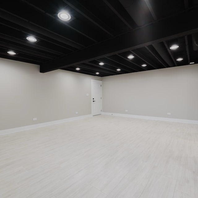 basement with light hardwood / wood-style floors