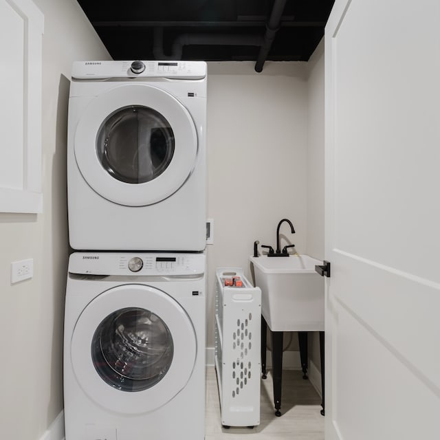 laundry room with stacked washing maching and dryer