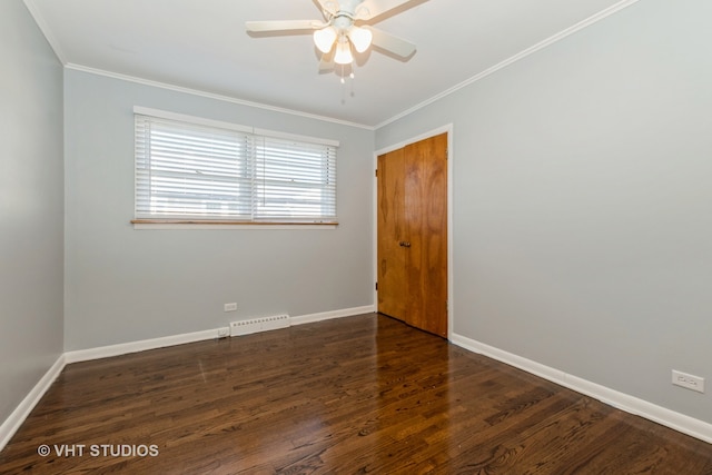 spare room featuring ornamental molding, ceiling fan, and dark hardwood / wood-style floors