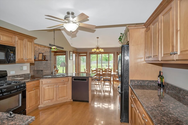 kitchen with kitchen peninsula, sink, black appliances, light hardwood / wood-style flooring, and hanging light fixtures