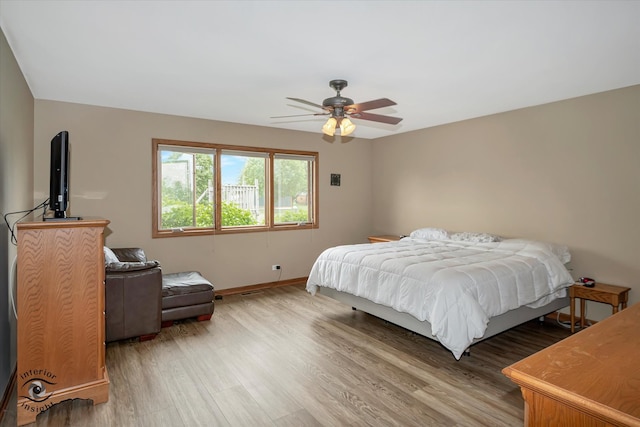 bedroom featuring hardwood / wood-style floors and ceiling fan