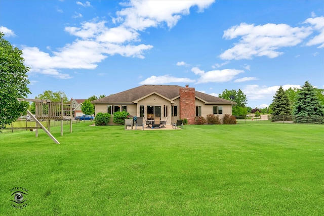 back of house with a lawn and a patio area