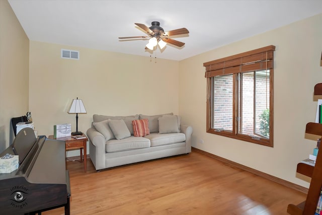 living room featuring ceiling fan and light wood-type flooring