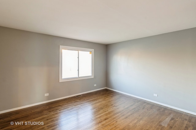 empty room featuring dark hardwood / wood-style flooring