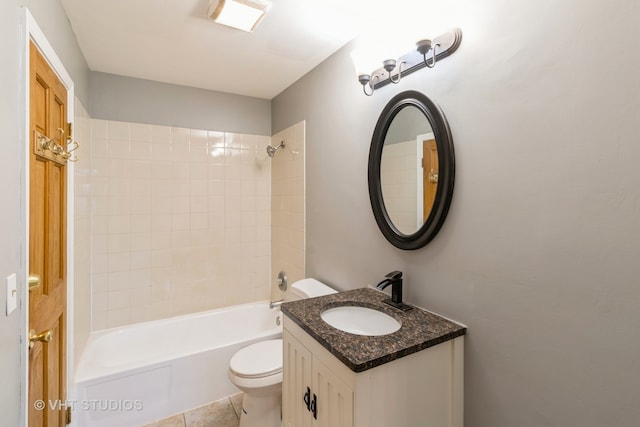 full bathroom featuring tile patterned floors, vanity, tiled shower / bath combo, and toilet