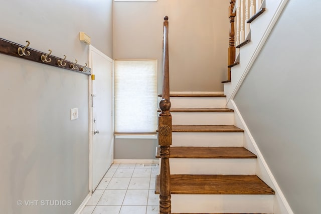 stairway with tile patterned flooring