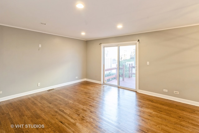 spare room with hardwood / wood-style flooring and ornamental molding