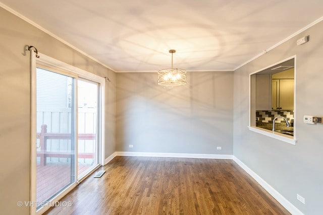 unfurnished room with dark wood-type flooring, a chandelier, and ornamental molding