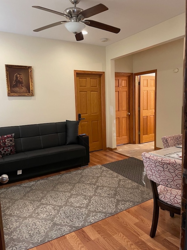 living room featuring ceiling fan and wood-type flooring