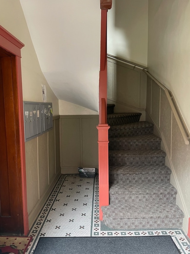 stairway featuring vaulted ceiling