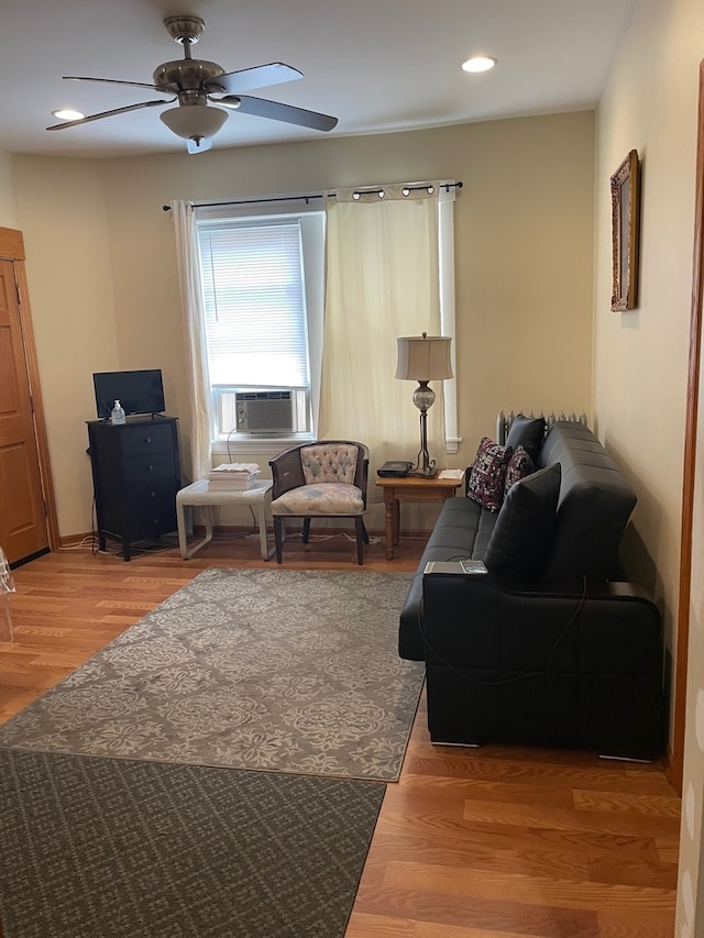 living room featuring cooling unit, hardwood / wood-style floors, and ceiling fan