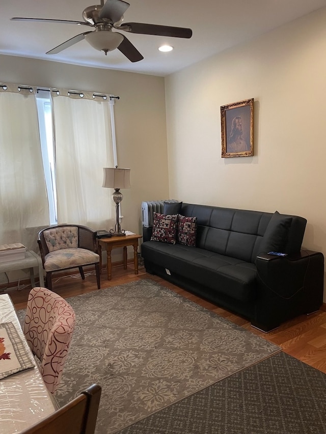 living room featuring hardwood / wood-style floors and ceiling fan