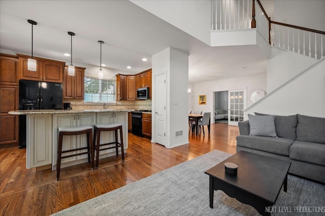 living room featuring dark hardwood / wood-style flooring and sink