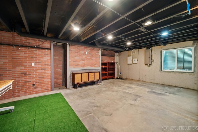 basement with electric panel and brick wall