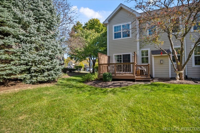 back of house featuring a deck and a lawn