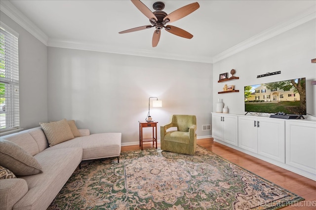 living room with ceiling fan, light wood-type flooring, and crown molding