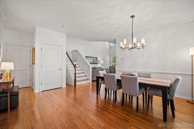 dining space featuring a chandelier and light hardwood / wood-style floors