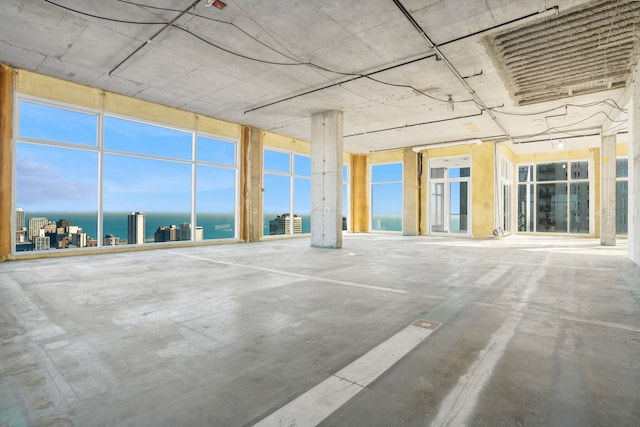 unfurnished sunroom featuring a water view