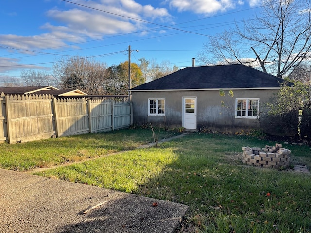 rear view of house with a lawn