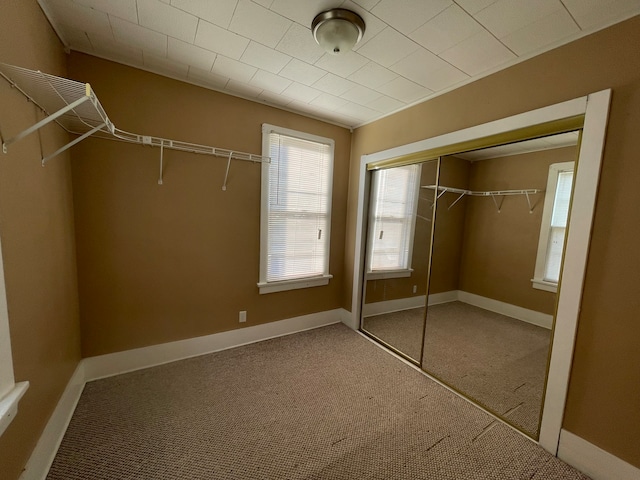 unfurnished bedroom with carpet floors and a closet