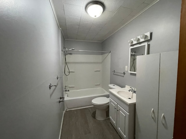 full bathroom featuring crown molding, hardwood / wood-style floors, toilet, shower / washtub combination, and vanity