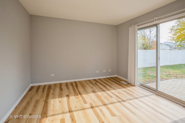 spare room featuring light hardwood / wood-style flooring