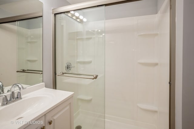 bathroom with vanity and a shower with shower door