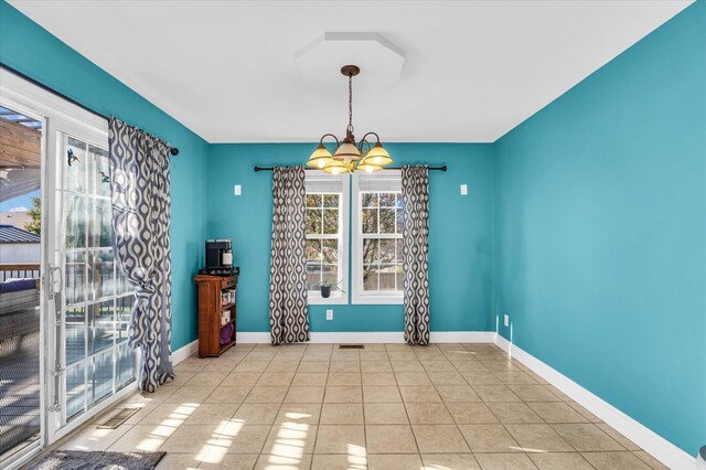 unfurnished dining area featuring light tile patterned floors and a chandelier