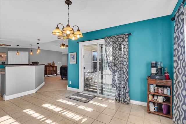 unfurnished dining area with light tile patterned flooring, ceiling fan with notable chandelier, and vaulted ceiling