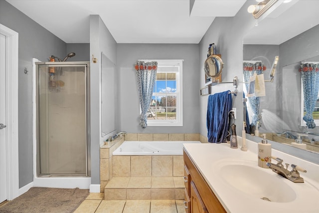 bathroom featuring tile patterned flooring, shower with separate bathtub, and vanity