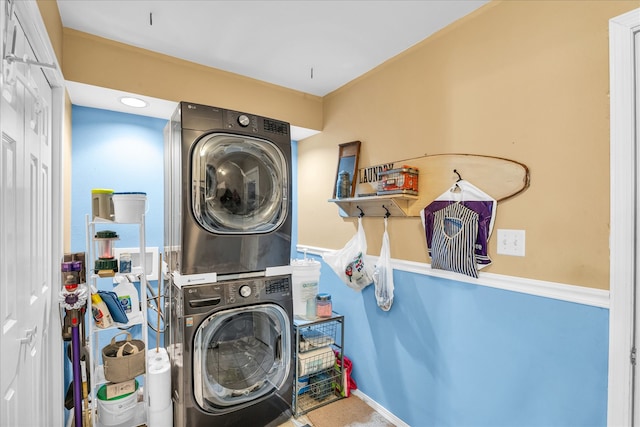 clothes washing area featuring stacked washer / dryer