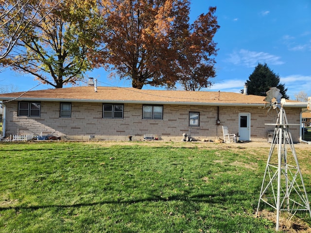 rear view of property featuring a yard