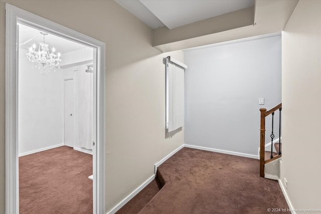 interior space with dark colored carpet and a notable chandelier