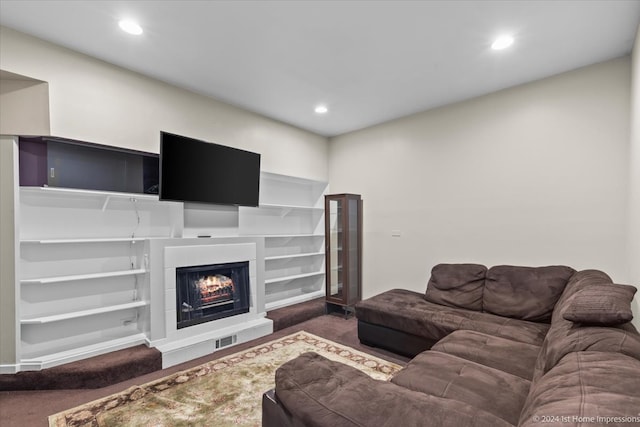 living room featuring built in features and dark colored carpet