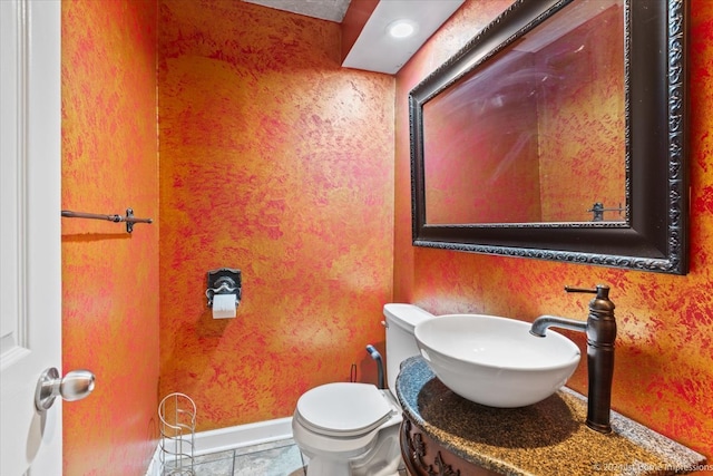 bathroom with tile patterned flooring, sink, and toilet