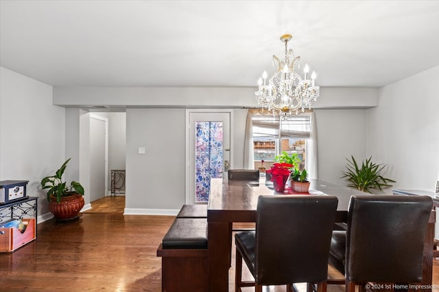 dining space with a chandelier and dark hardwood / wood-style floors