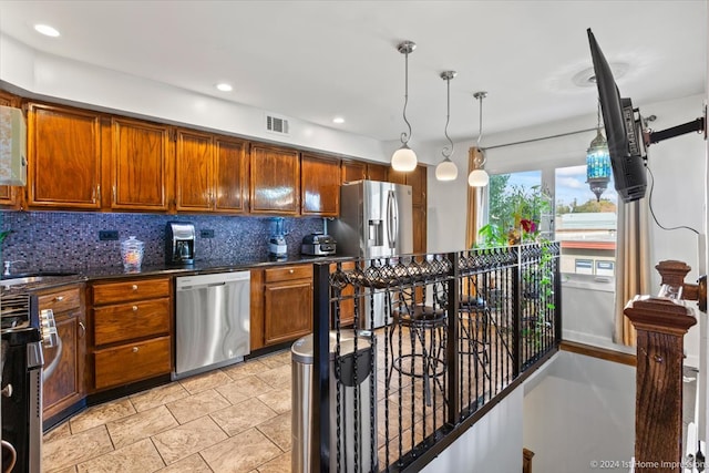 kitchen with decorative backsplash, hanging light fixtures, stove, sink, and stainless steel dishwasher