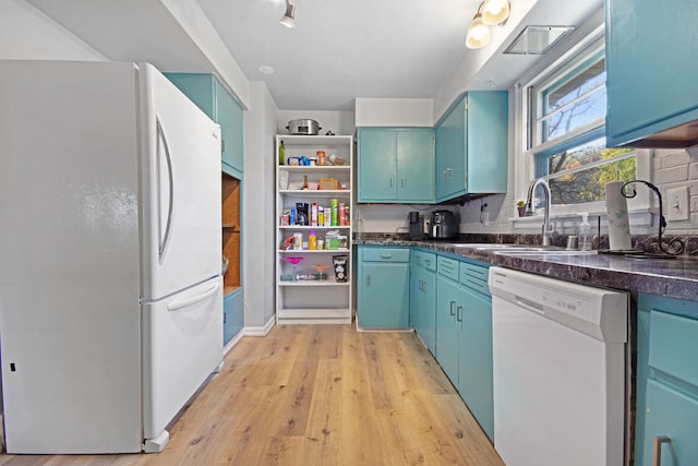 kitchen with tasteful backsplash, white appliances, sink, and light hardwood / wood-style floors