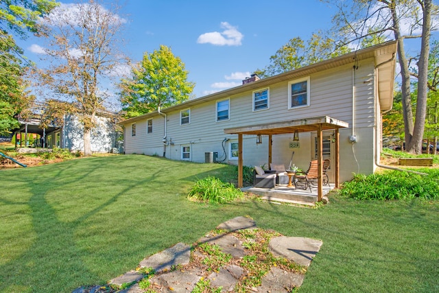 rear view of property featuring central air condition unit, a patio area, and a lawn