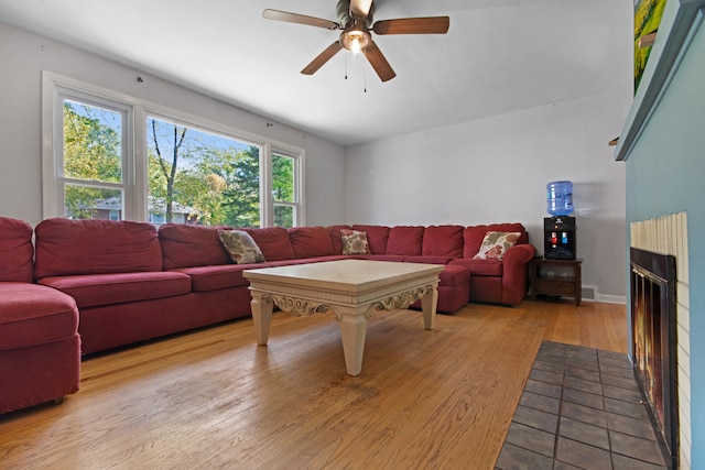 living room with light hardwood / wood-style floors and ceiling fan