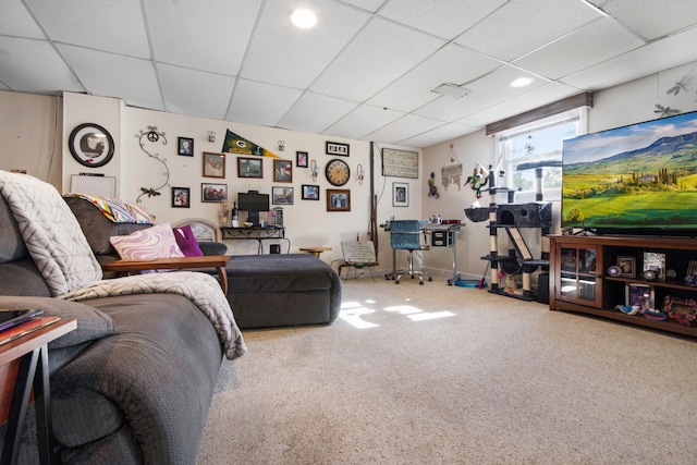 carpeted living room with a paneled ceiling