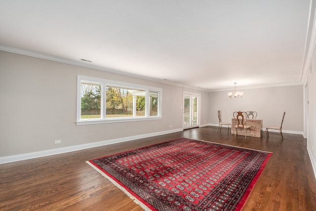 living room with crown molding, dark hardwood / wood-style flooring, and a chandelier