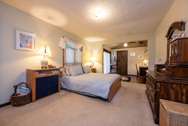 bedroom featuring light colored carpet and a textured ceiling