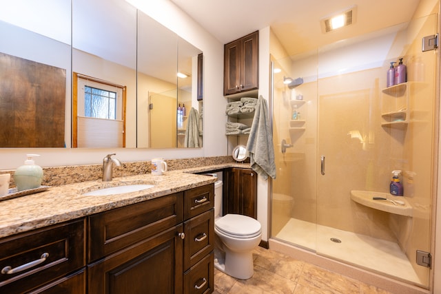 bathroom featuring vanity, an enclosed shower, tile patterned floors, and toilet