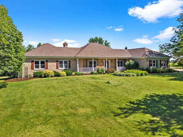 ranch-style house with a front lawn and covered porch