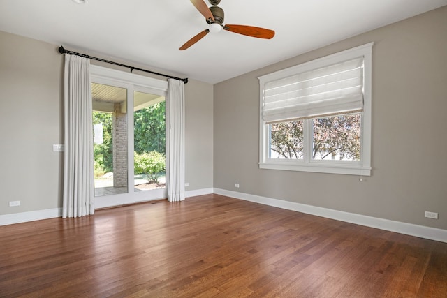 empty room featuring dark hardwood / wood-style flooring and ceiling fan