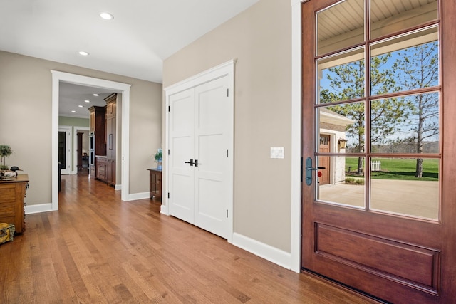 foyer entrance with light hardwood / wood-style floors